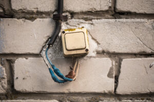 Technician using advanced metering infrastructure to detect electricity theft